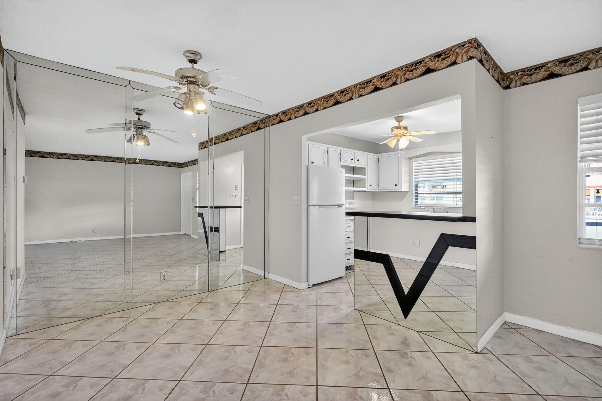 5300 Washington Street, Unit J116 Hollywood, FL 33021 - Photo 18 of 36 a view of a livingroom with a chandelier fan and windows