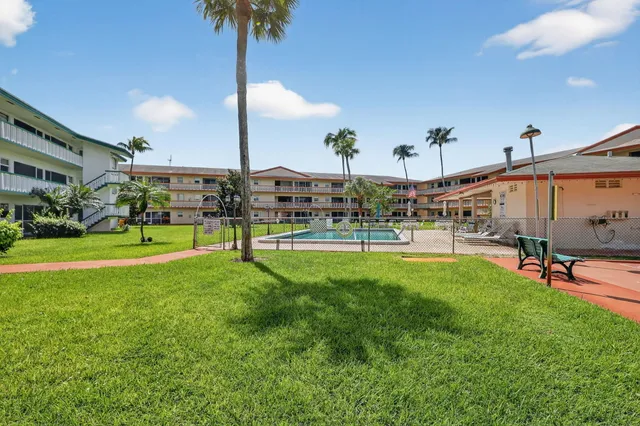 a view of a big yard with palm trees