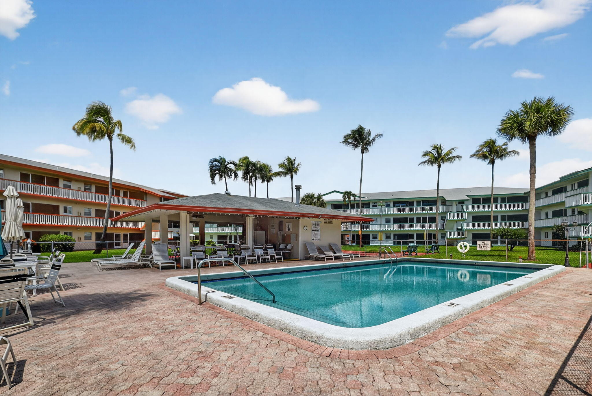 5300 Washington Street, Unit J116 Hollywood, FL 33021 - Photo 36 of 36 a view of a swimming pool and a chairs