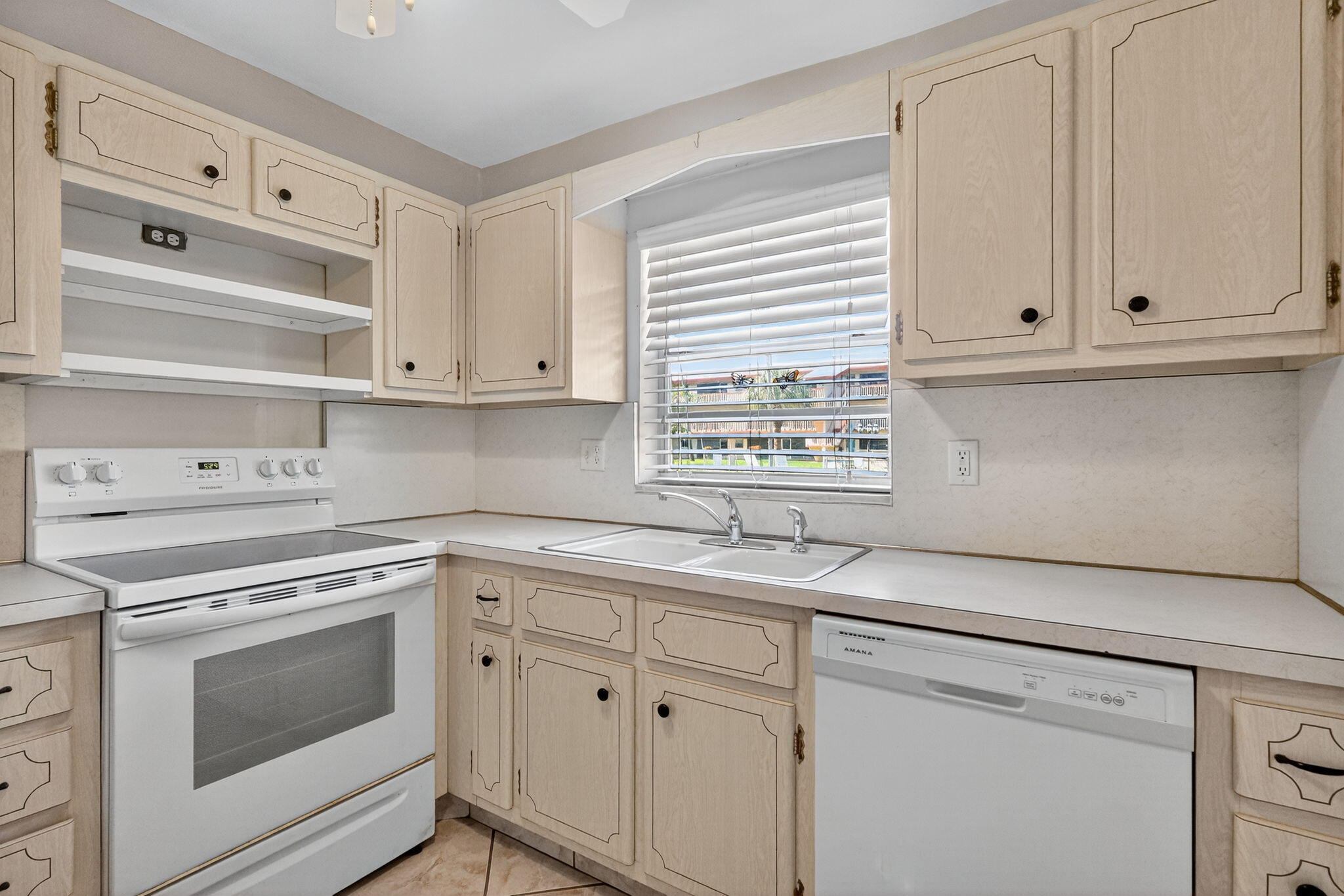 5300 Washington Street, Unit J116 Hollywood, FL 33021 - Photo 4 of 36 a kitchen with granite countertop white cabinets and white appliances
