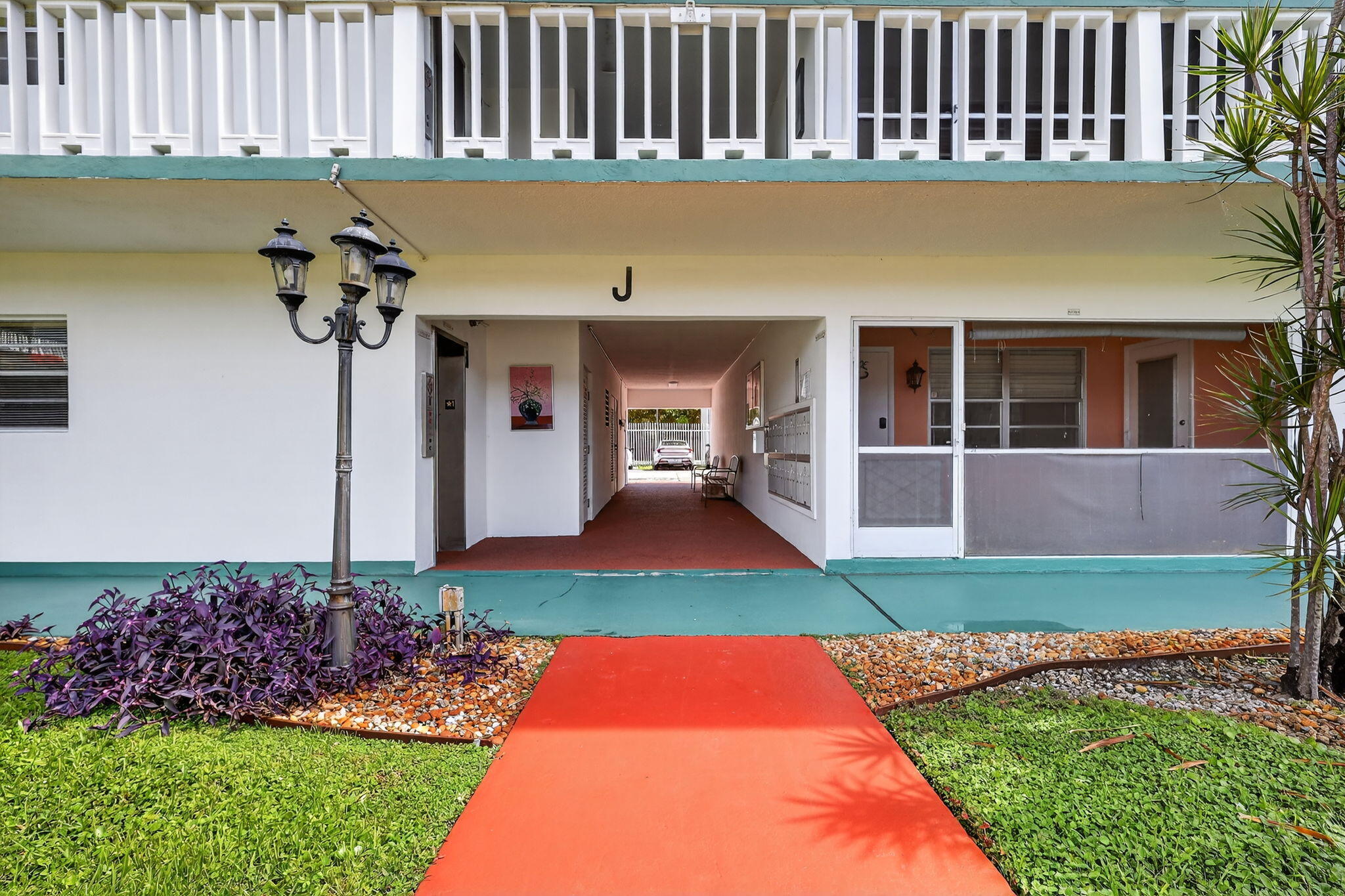 5300 Washington Street, Unit J116 Hollywood, FL 33021 - Photo 8 of 36 a front view of a house with a garden and plants