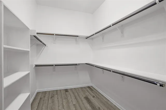 a view of a room with wooden floor