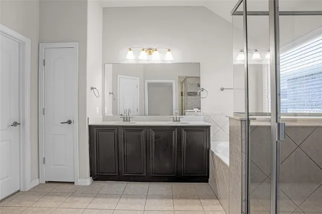a bathroom with a mirror and a shower