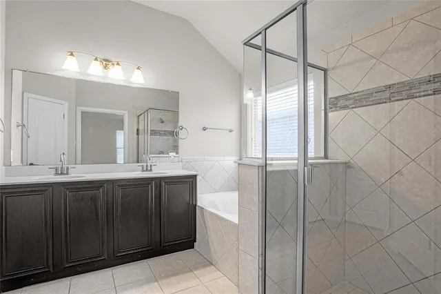 a spacious bathroom with a double vanity sink a mirror and shower