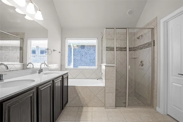 a bathroom with a shower sink and mirror