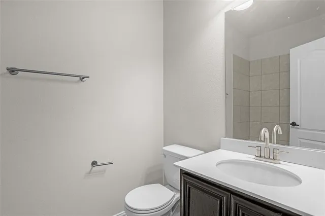a bathroom with a sink toilet vanity and shower