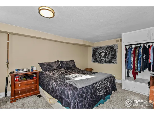 a bedroom with a bed and a television