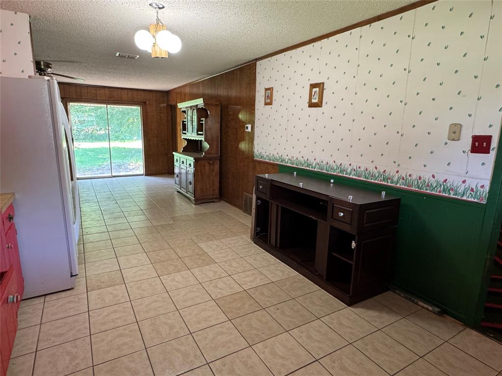 415 Meadowlark Trail Springtown, TX 76082 - Photo 8 of 40 a kitchen with granite countertop a stove a sink and a refrigerator