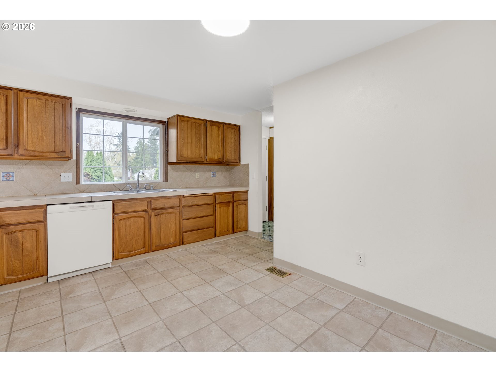 211 Southwest Royal Court Gresham, OR 97030 - Photo 13 of 37 a kitchen with a sink cabinets and window