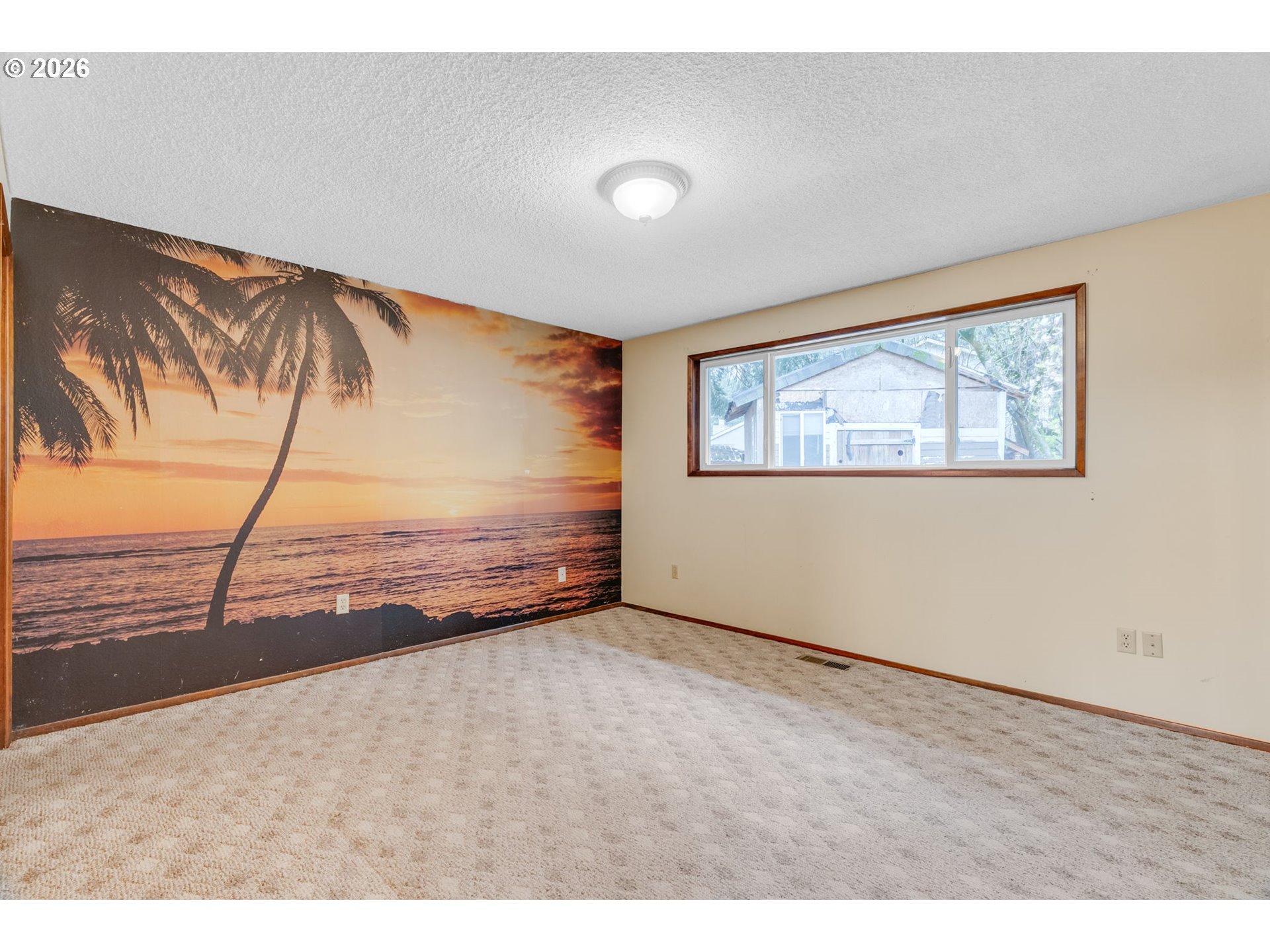 211 Southwest Royal Court Gresham, OR 97030 - Photo 19 of 37 a view of an empty room with wooden floor and a painting on the wall