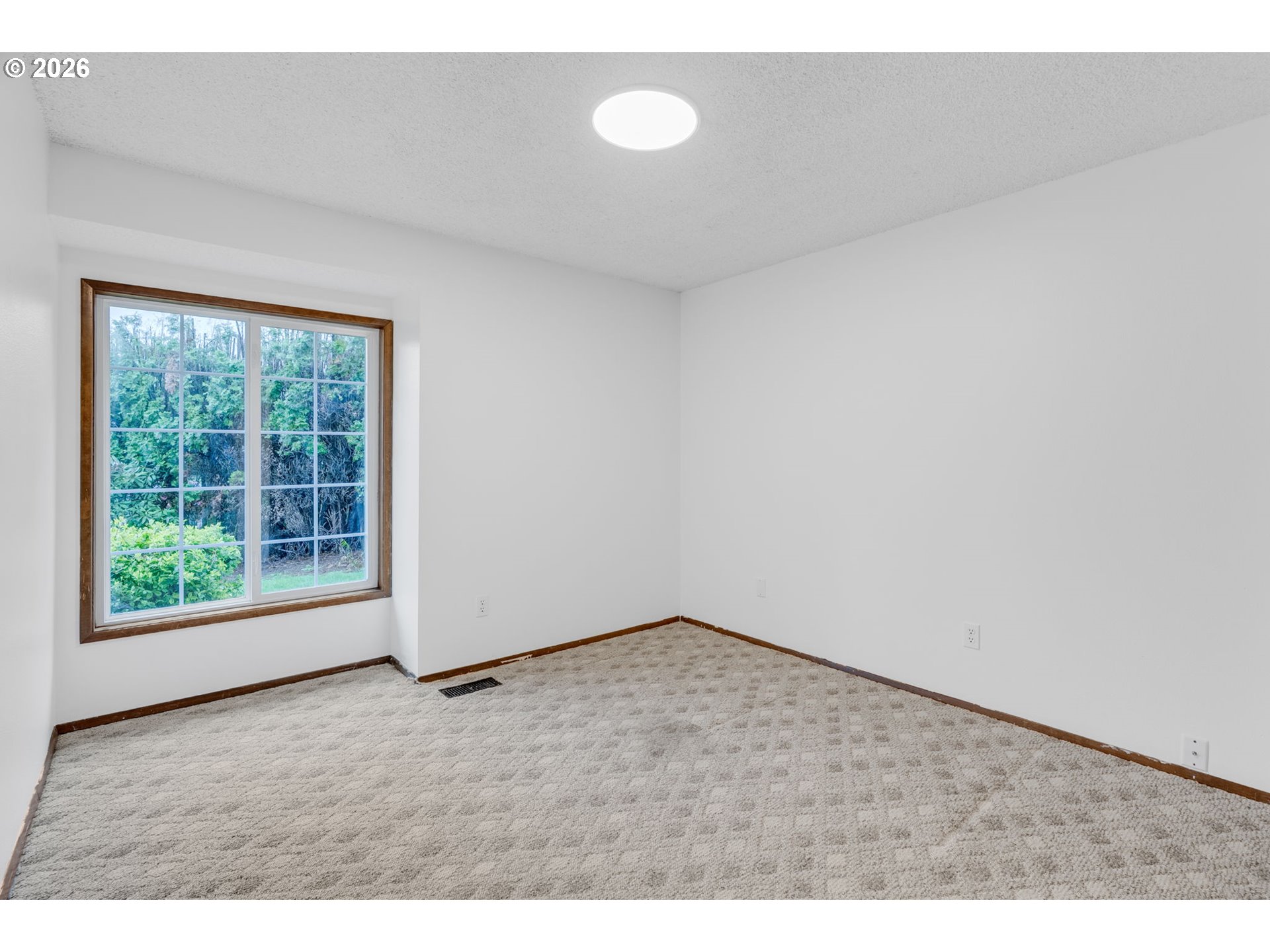 211 Southwest Royal Court Gresham, OR 97030 - Photo 24 of 37 a view of an empty room with wooden floor and a window