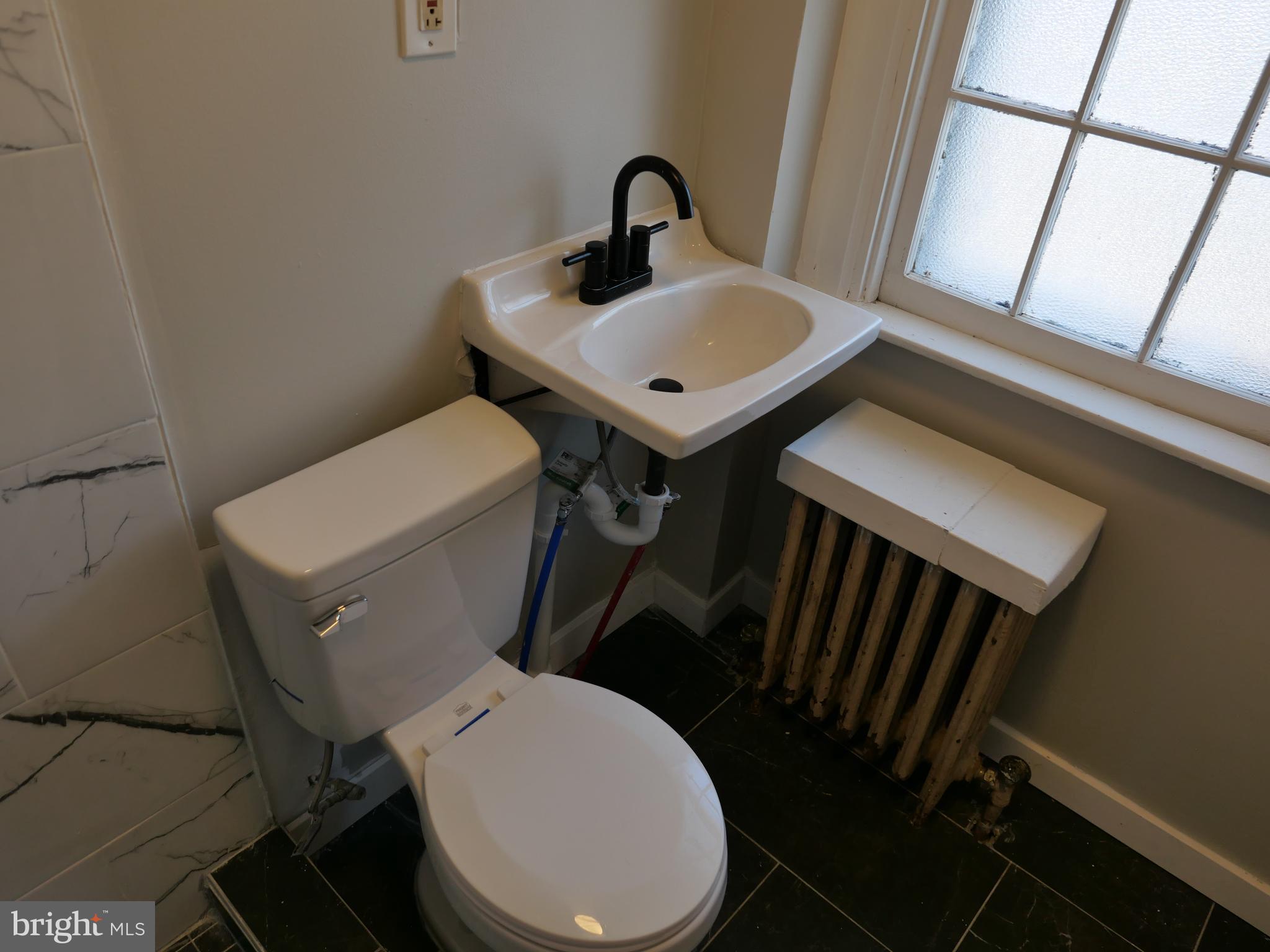 313 Hampden Road Upper Darby, PA 19082 - Photo 11 of 12 a bathroom with a toilet sink and mirror