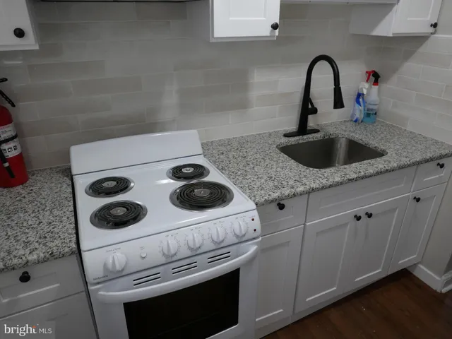 a kitchen with a stove and a sink