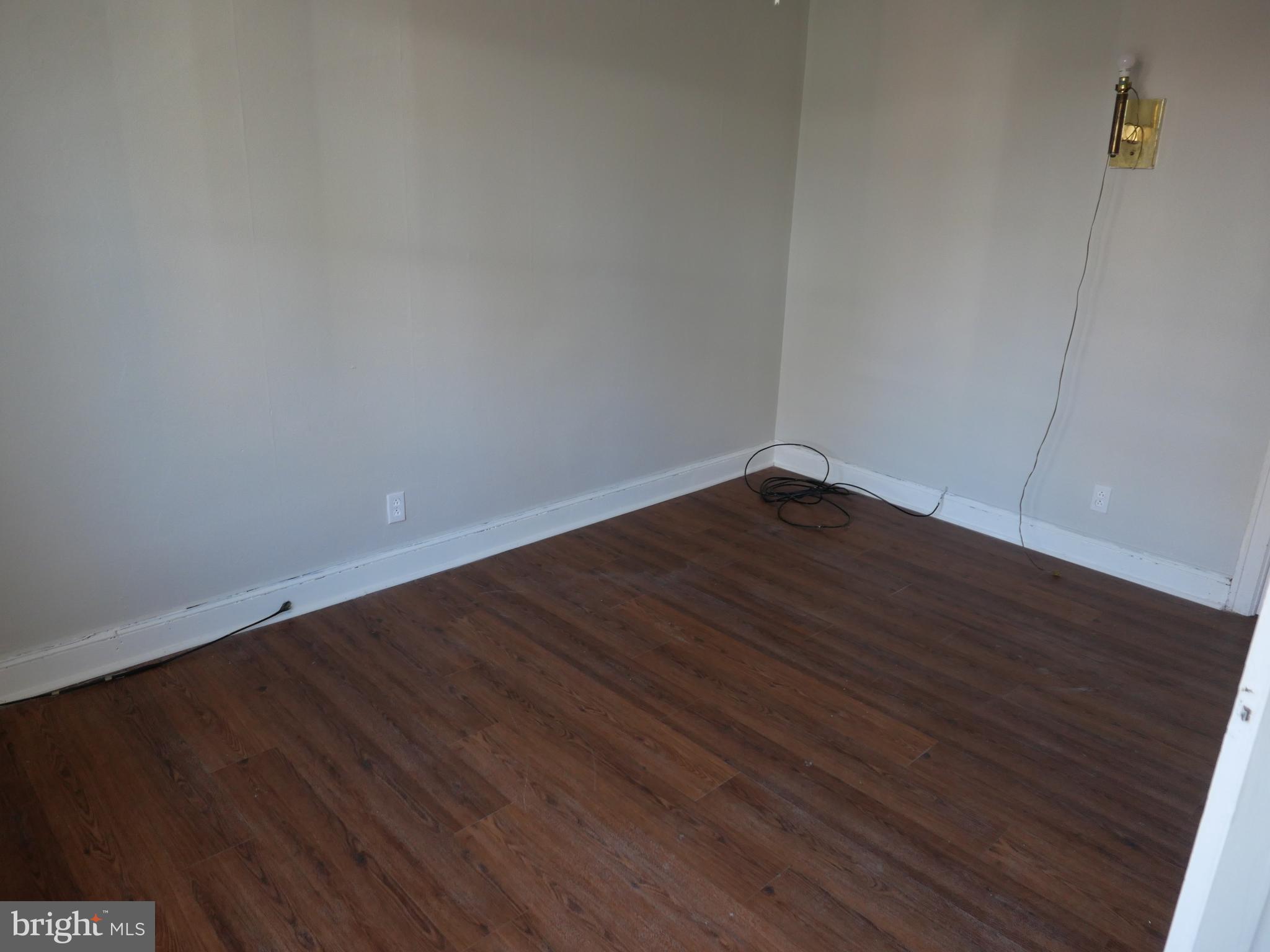 313 Hampden Road Upper Darby, PA 19082 - Photo 8 of 12 a view of an empty room with wooden floor