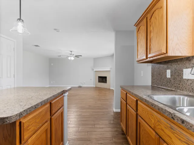 a kitchen with granite countertop a sink and a stove