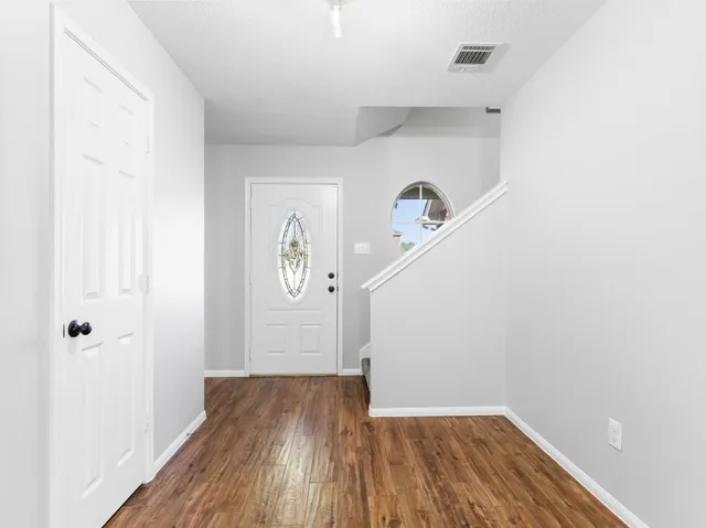a view of a hallway with wooden floor