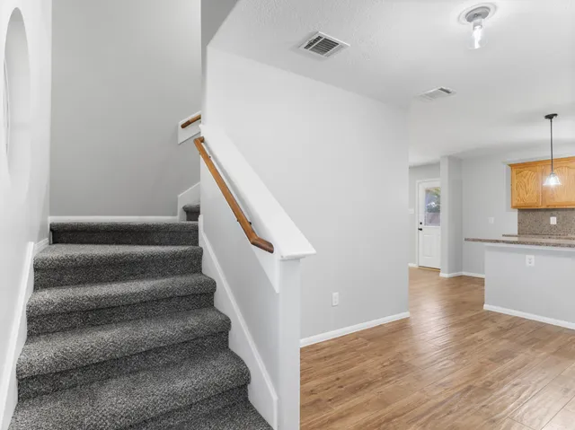 a view of entryway and hall with wooden floor