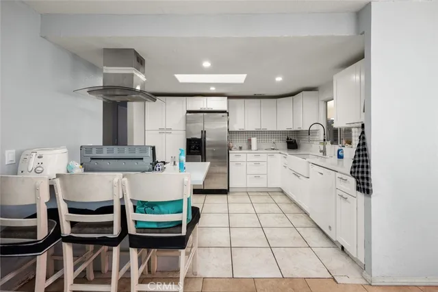 a kitchen with a sink cabinets and window