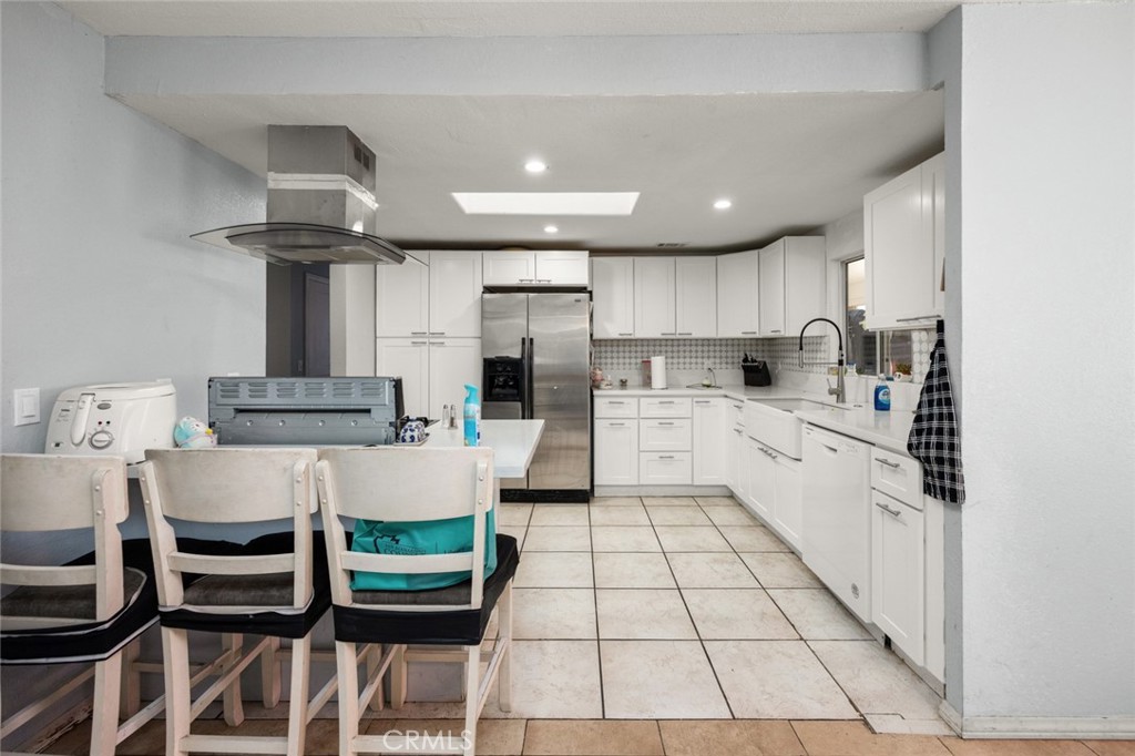 18629 Orange Street Hesperia, CA 92345 - Photo 11 of 46 a kitchen with a sink cabinets and window