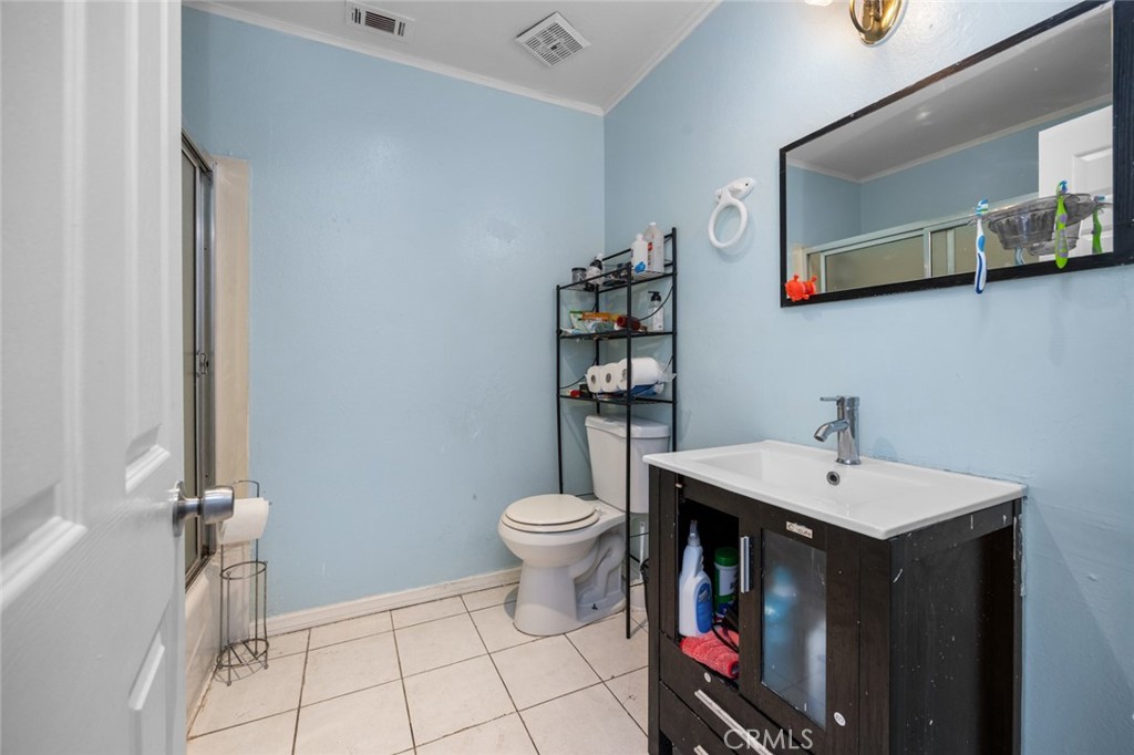 18629 Orange Street Hesperia, CA 92345 - Photo 27 of 46 a bathroom with a sink a toilet and a mirror