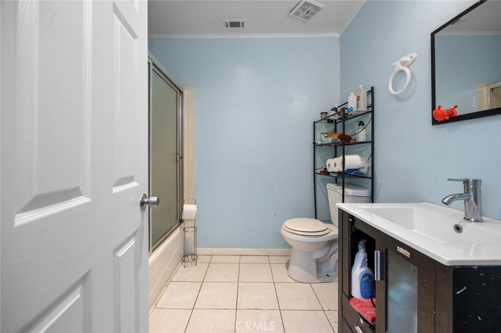 18629 Orange Street Hesperia, CA 92345 - Photo 28 of 46 a bathroom with a sink a toilet and a mirror