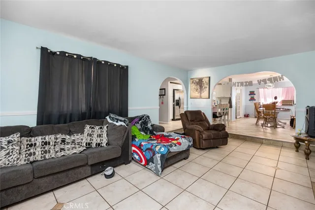 a bedroom with furniture and a large window
