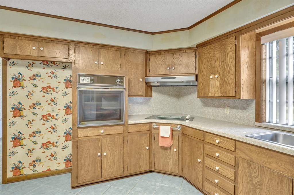 1368 County Road 2206 Rusk, TX 75785 - Photo 11 of 32 a kitchen with a refrigerator oven and a sink
