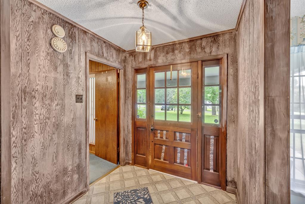 1368 County Road 2206 Rusk, TX 75785 - Photo 4 of 32 a view of a hallway with windows and chandelier
