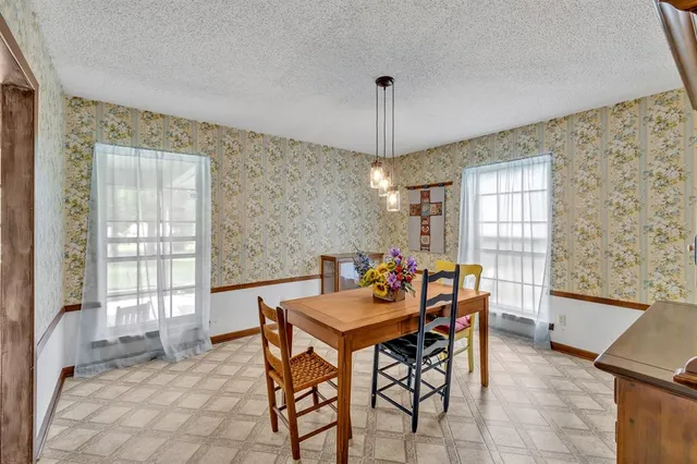 a large kitchen with a large window and stainless steel appliances