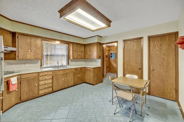 a kitchen with cabinets a sink and wooden cabinets