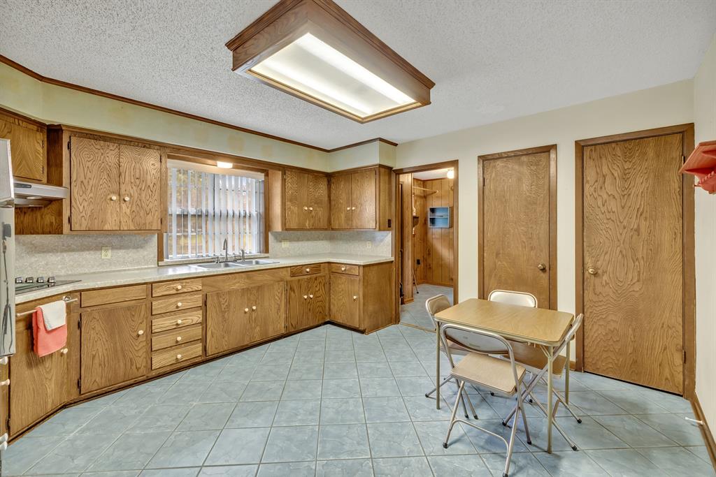 1368 County Road 2206 Rusk, TX 75785 - Photo 9 of 32 a large kitchen with a large window and stainless steel appliances