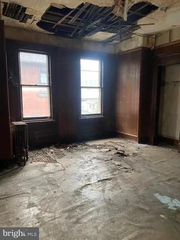 a view of empty room with a floor to ceiling window