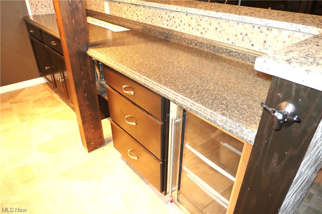215 Home Street Rittman, OH 44270 - Photo 10 of 16 Behind the bar with cabinets, drawers and a built-in refrigerator.