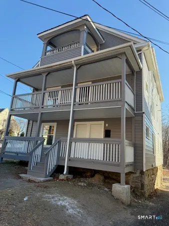 a view of a house with wooden deck