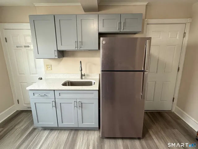 a white refrigerator freezer sitting inside of a kitchen
