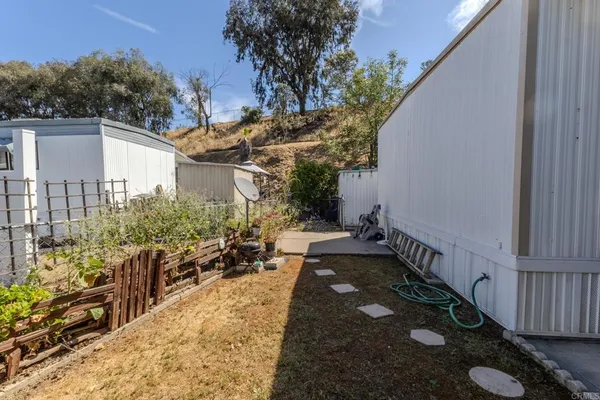 a view of a chairs and table in a backyard