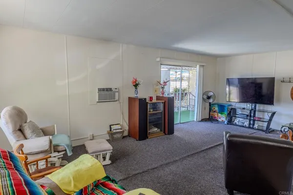 a living room with furniture and a floor to ceiling window