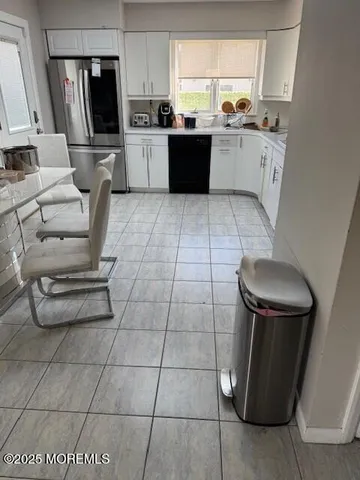 a kitchen with stainless steel appliances a refrigerator sink and microwave