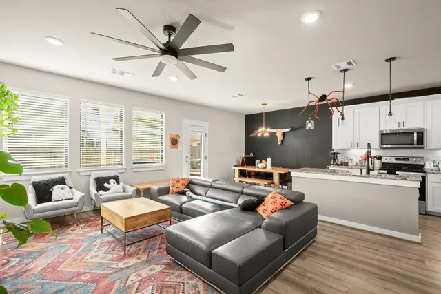 a living room with furniture and kitchen view
