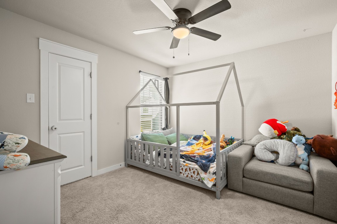 195 C Waterside Road Buda, TX 78610 - Photo 12 of 27 Bedroom with light colored carpet and ceiling fan