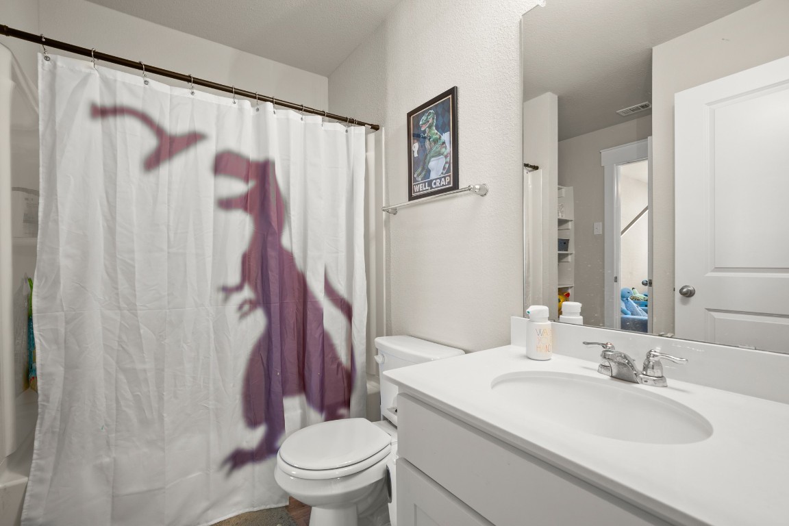 195 C Waterside Road Buda, TX 78610 - Photo 16 of 27 Full bath with vanity and shower / bath combo with shower curtain