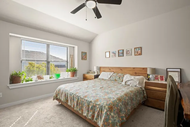 a bed sitting in a bedroom next to a window