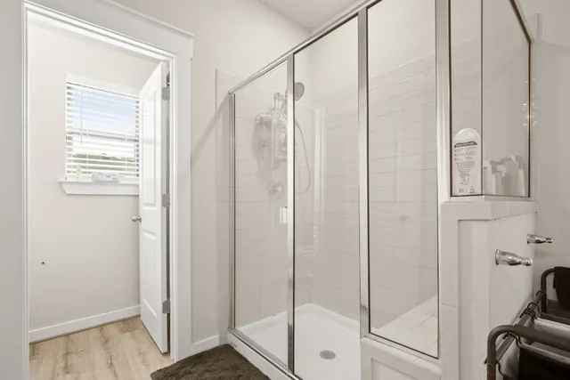 a bathroom with a shower and a glass door