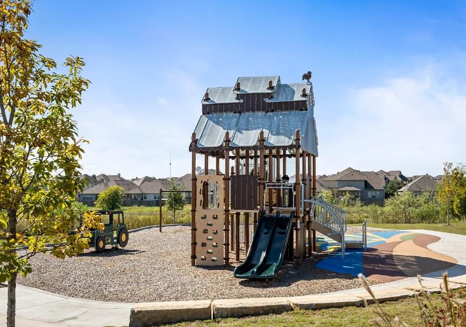 195 C Waterside Road Buda, TX 78610 - Photo 23 of 27 Communal playground featuring a residential view