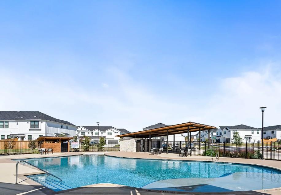 195 C Waterside Road Buda, TX 78610 - Photo 27 of 27 Community pool featuring a residential view and a patio