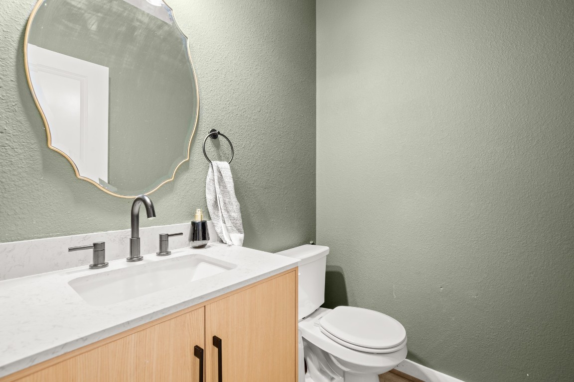 195 C Waterside Road Buda, TX 78610 - Photo 4 of 27 Bathroom with a textured wall and vanity