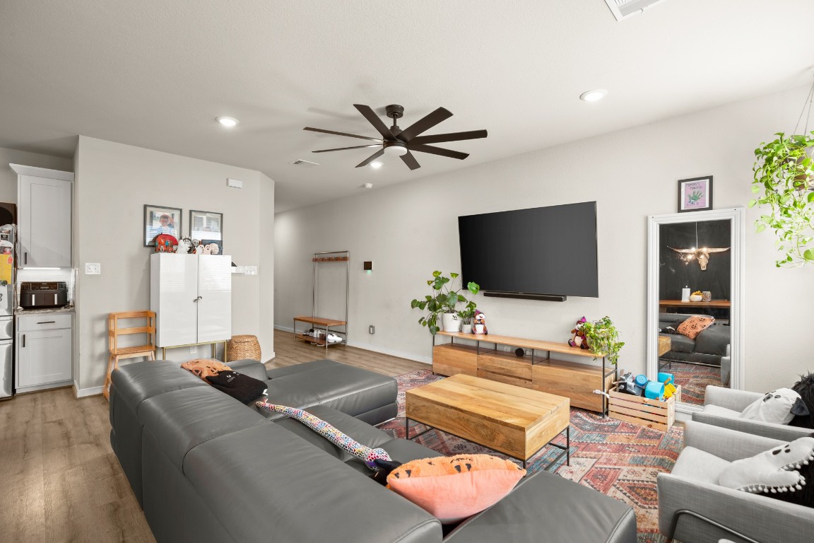 195 C Waterside Road Buda, TX 78610 - Photo 6 of 27 Living area featuring light wood-style flooring, a ceiling fan, and recessed lighting