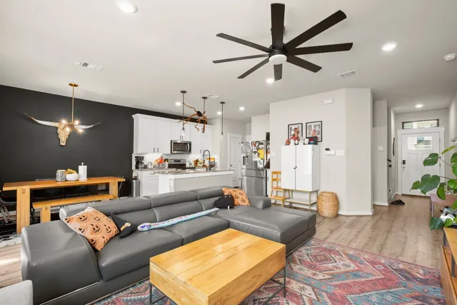 a living room with furniture and a wooden floor