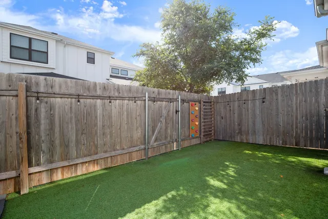 a view of a backyard with wooden fence