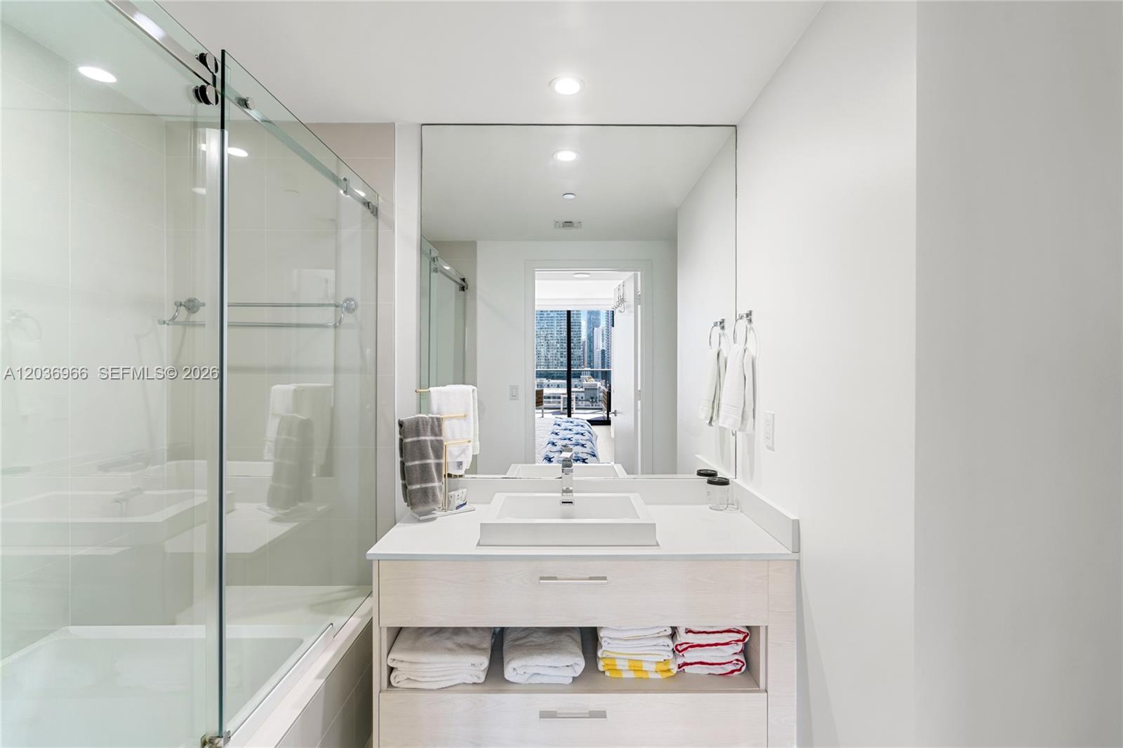 55 Southwest 9th Street, Unit 1904 Miami, FL 33130 - Photo 43 of 66 a bathroom with a sink shower and a mirror